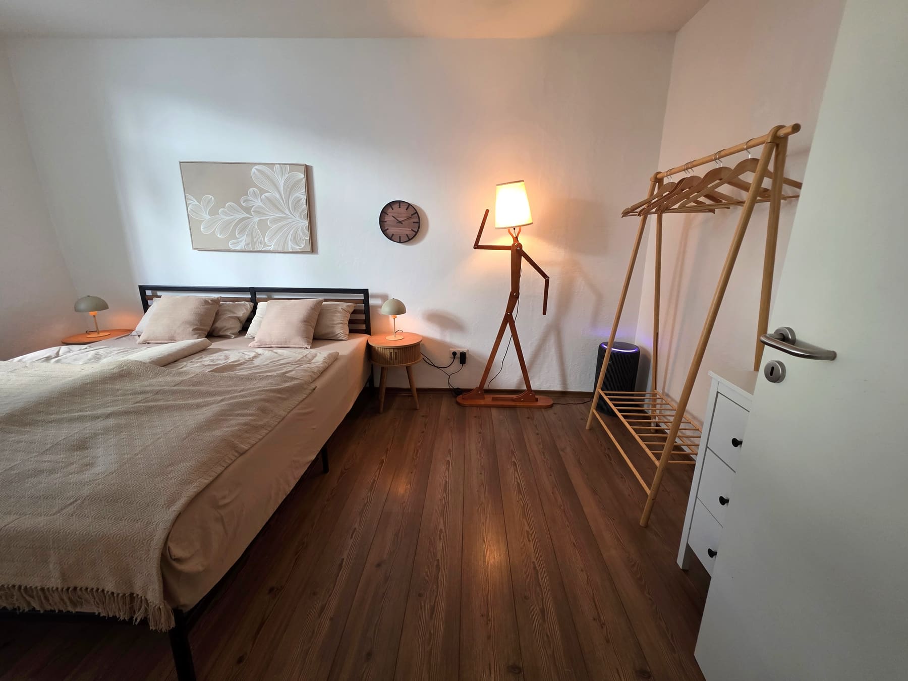 Bedroom with clothes rail and bedside lamp