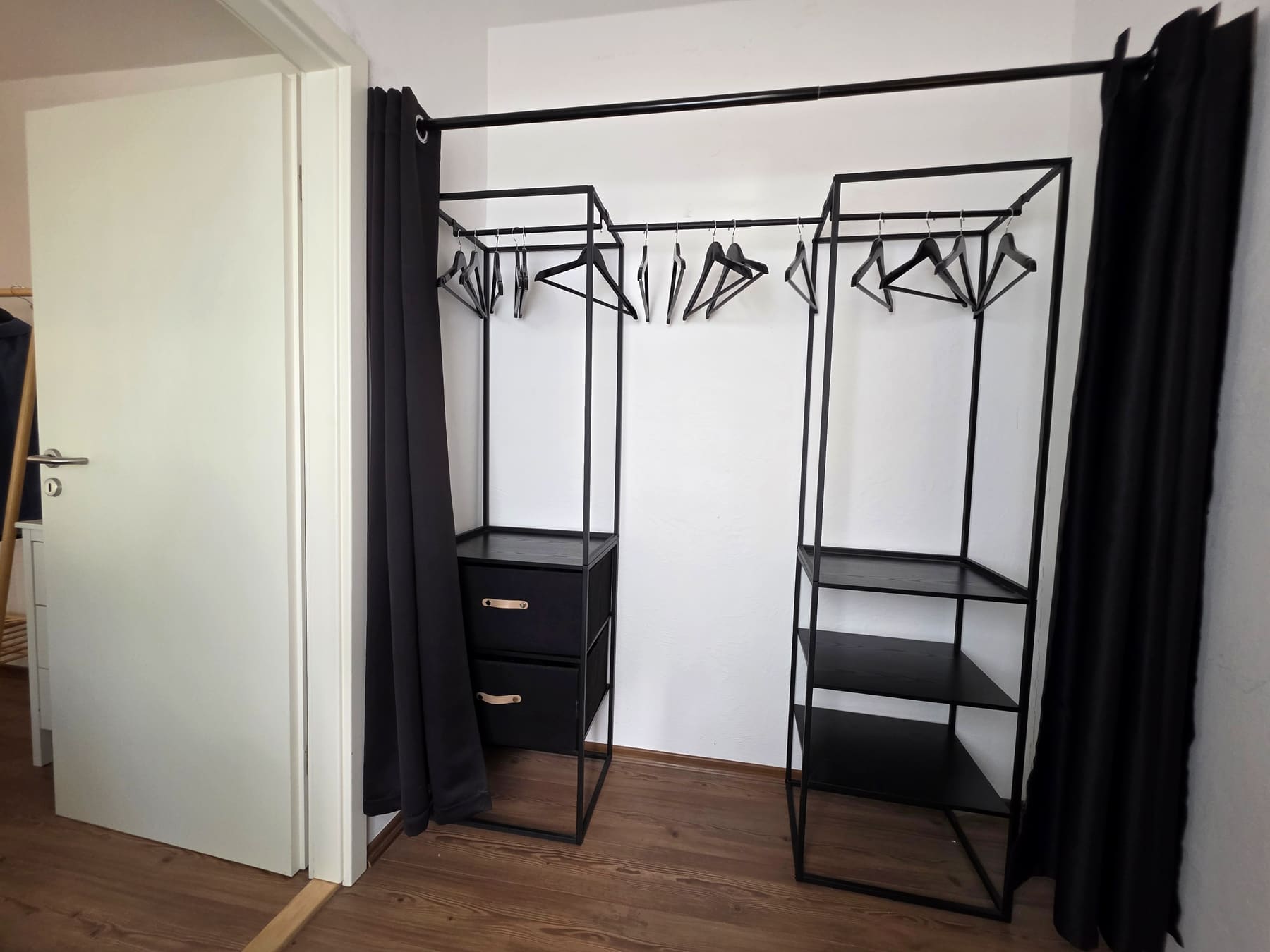 Open wardrobe with hangers and drawers