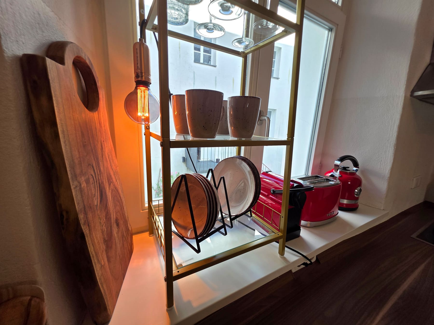 Kettle, boards and glasses on the kitchen shelf