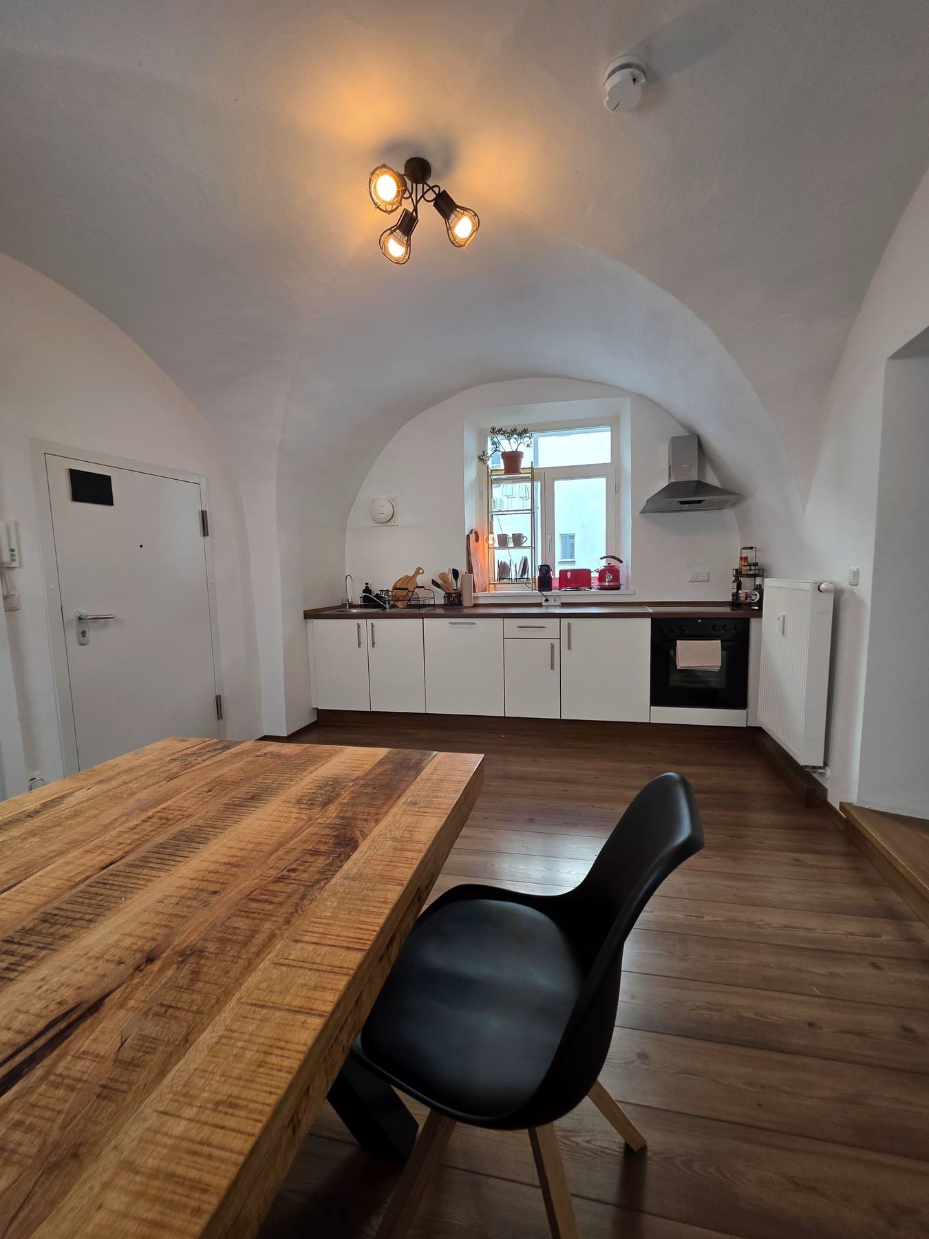 Kitchen seen from the big wooden table
