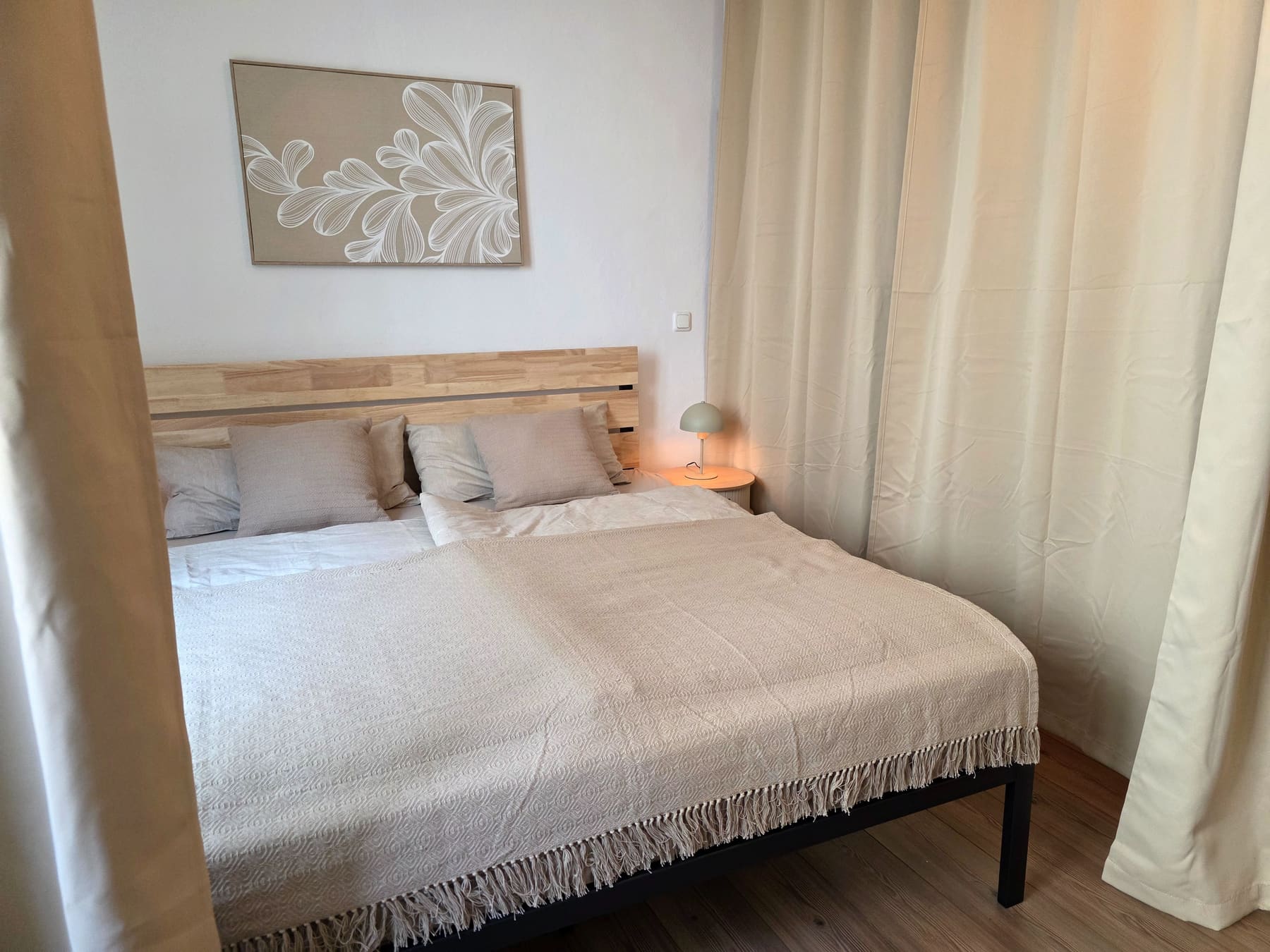 The corner bed with its wooden headboard