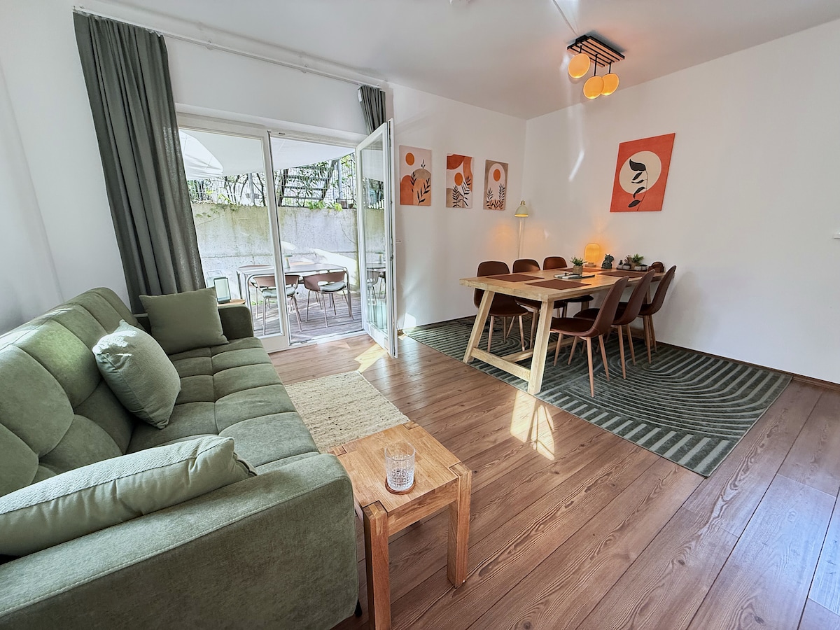 Sofa bed, the dining table and the open door to the terrace