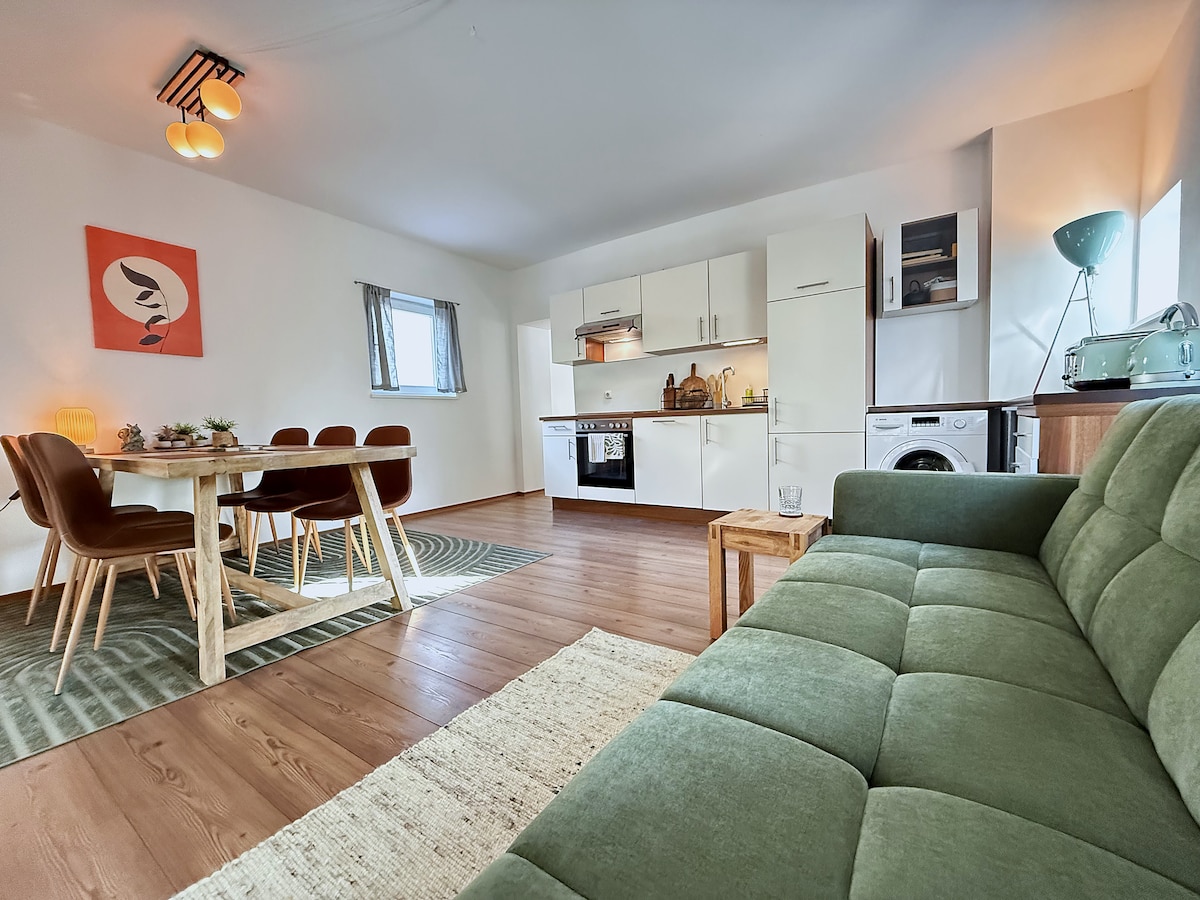 Kitchen, oven and the dining table seen from the sofa bed