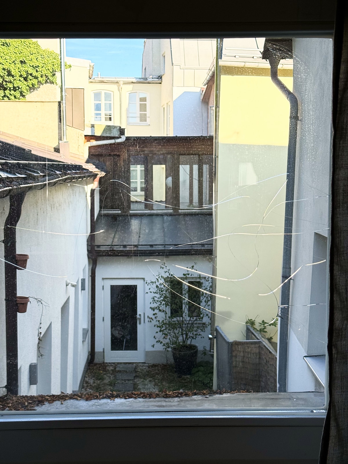 The cosmetic crack in the kitchen window, the courtyard beyond