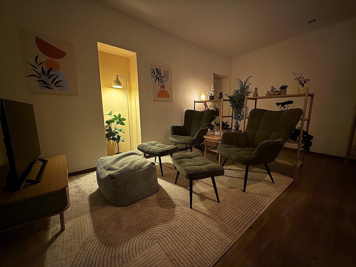 Living room in the evening, the floor lamp on in the alcove