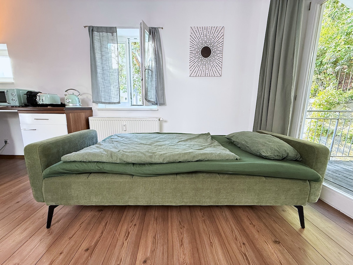 The 120 cm sofa bed in the kitchen and dining area made up as a bed