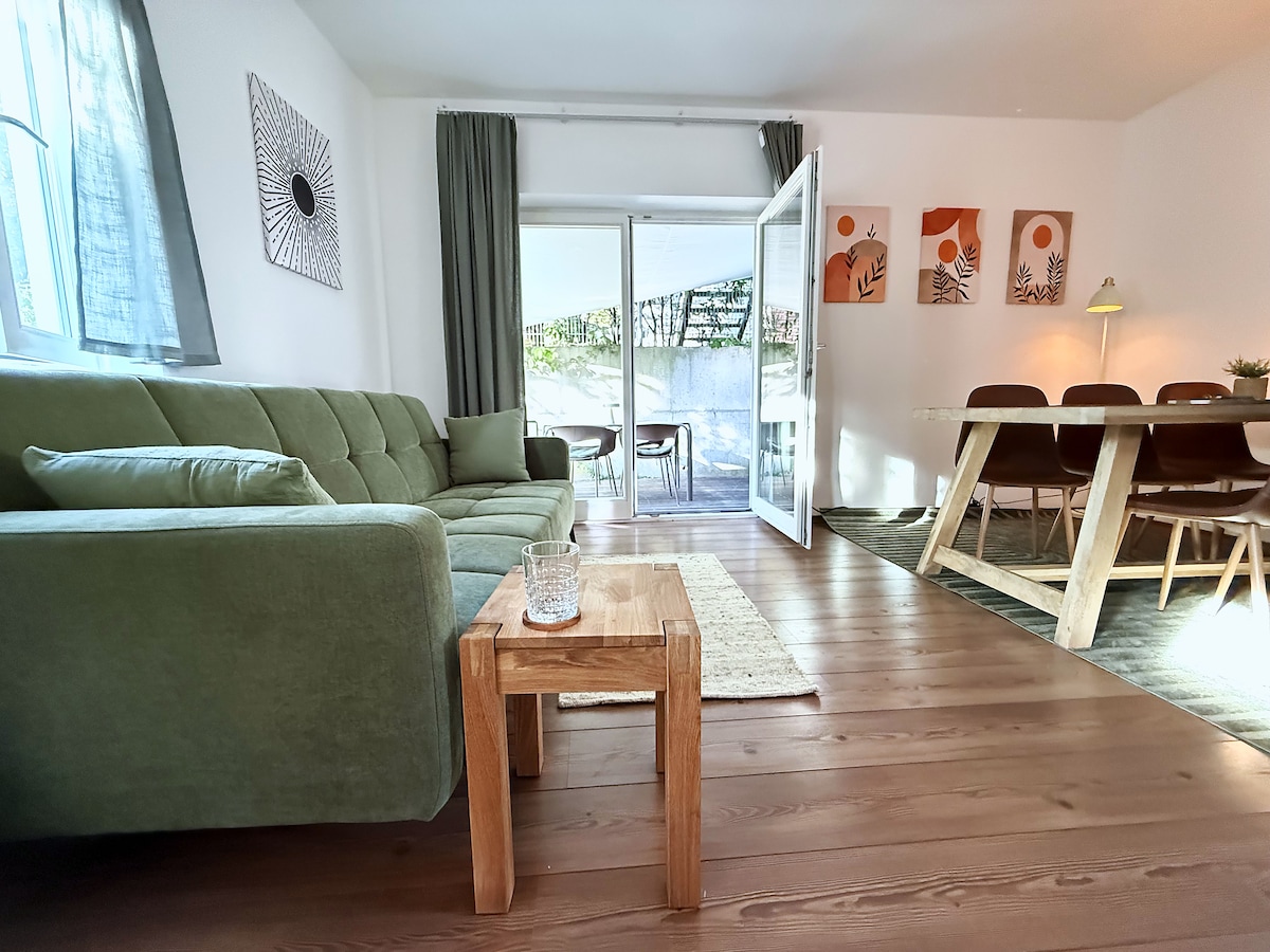 Sofa bed and coffee table, the dining table and the terrace door behind