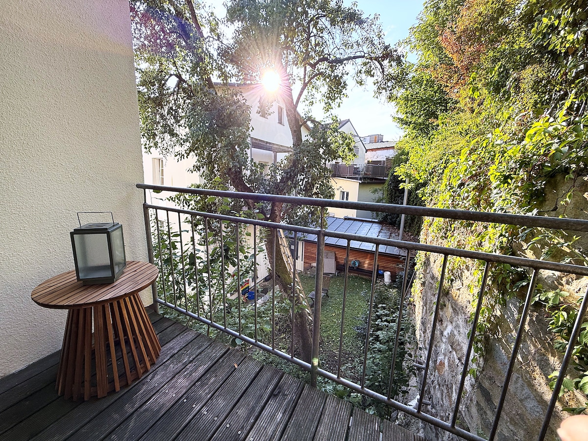 Terrace corner with the side table and lantern, looking out over the garden
